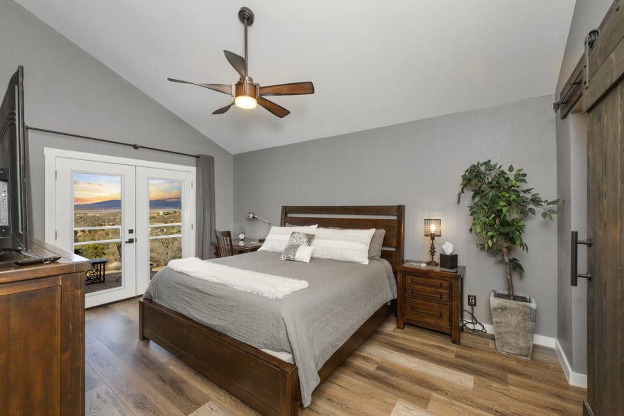 Bedroom #1, East-wing Master Bedroom, with work area desk, 55” Smart TV, private bathroom with AMAZING walk in rain shower, black-out curtains, private balcony with seating. 
