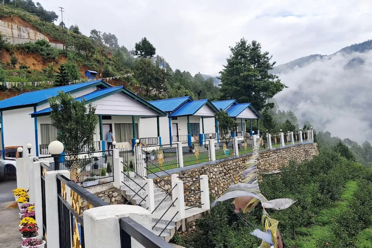 Scenic garden cottages and stone pathway at Wangdi's Resort in Dirang.
