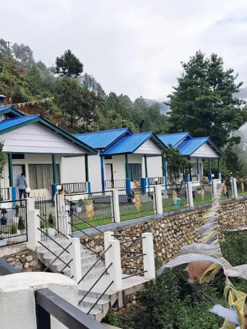 Scenic garden cottages and stone pathway at Wangdi's Resort in Dirang.
