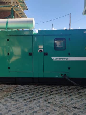 Outdoor SilentPower green diesel generator providing uninterrupted power backup.