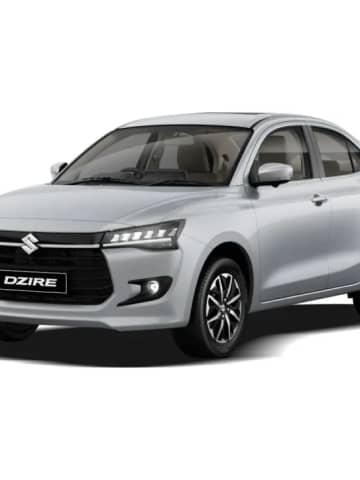 Maruti Suzuki Dzire compact sedan showcasing multi-slat black grille, LED headlights, and aerodynamic styling.