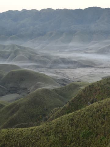 Panoramic vista across the undulating high-altitude meadows and rolling mountain ridges along the Nagaland border
