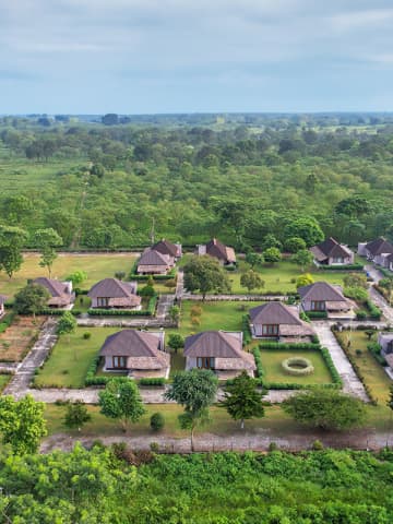 Aerial perspective of Musa Jungle Retreat cottage bungalows surrounded by landscaped gardens and tea plantations.
