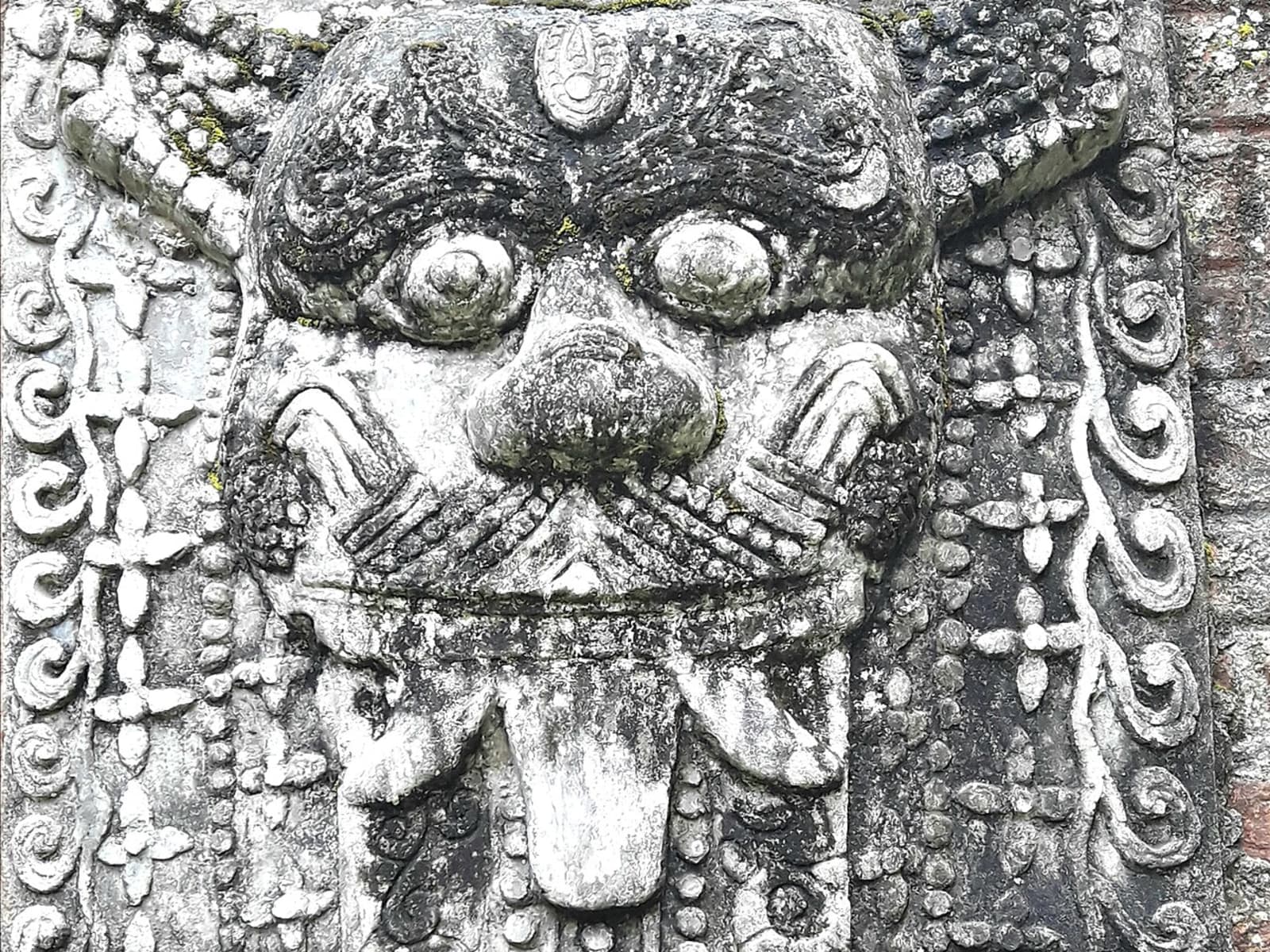 Stone slab showing the stylized face of a Kirtimukha mythical monster