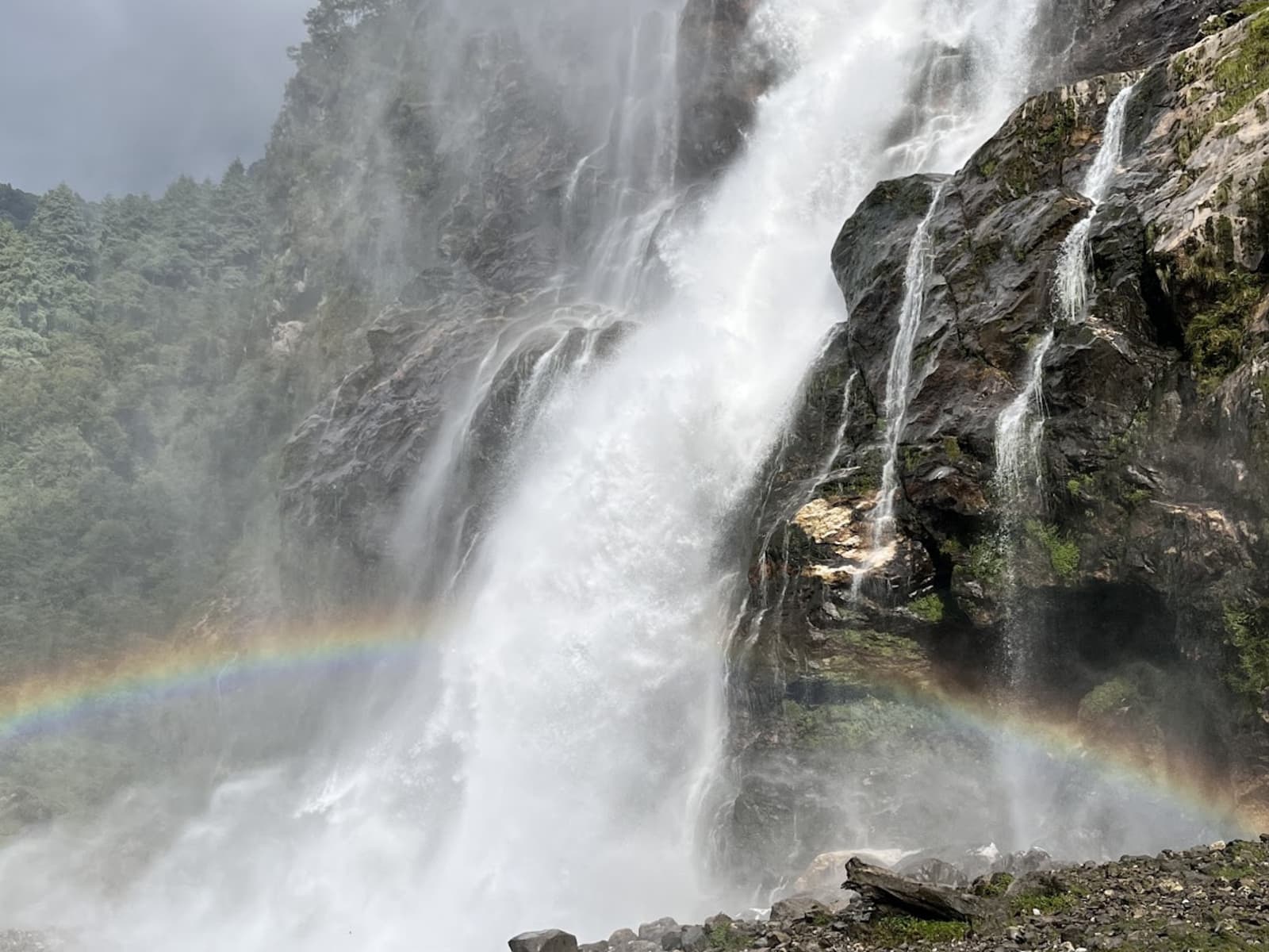 100-meter drop of Nuranang Waterfall plunging down rocky granite cliffs near Jang