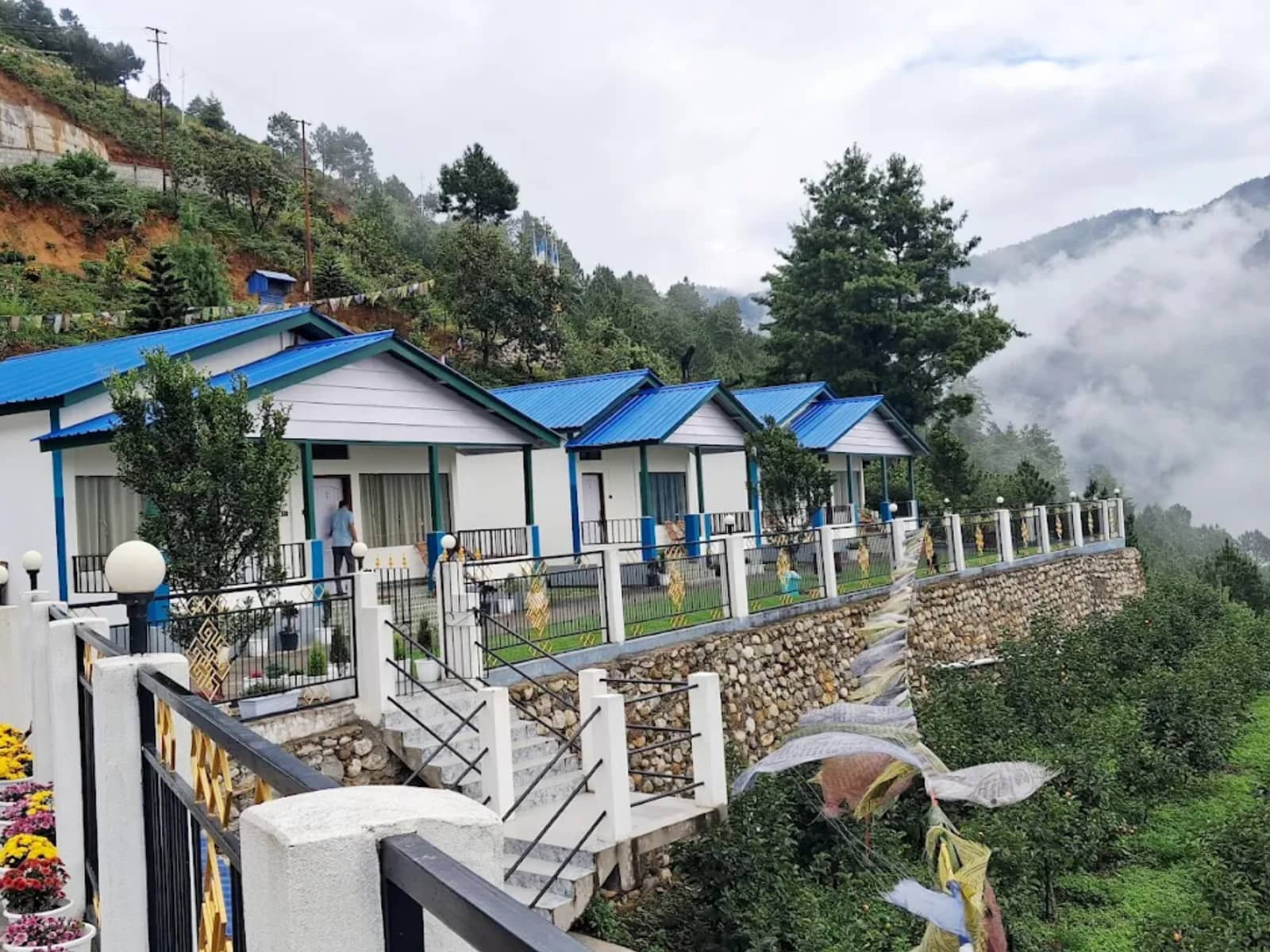Scenic garden cottages and stone pathway at Wangdi's Resort in Dirang.