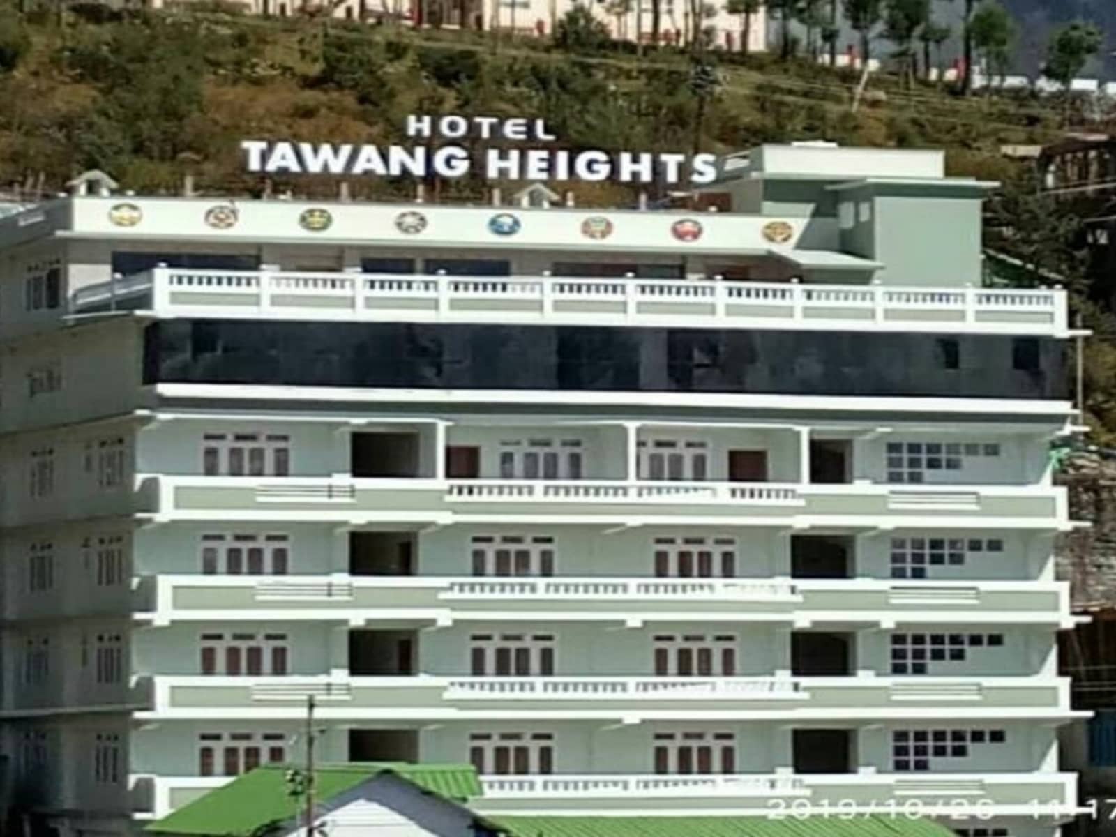 Hotel Tawang Heights main building facade set against Tawang mountain slopes.