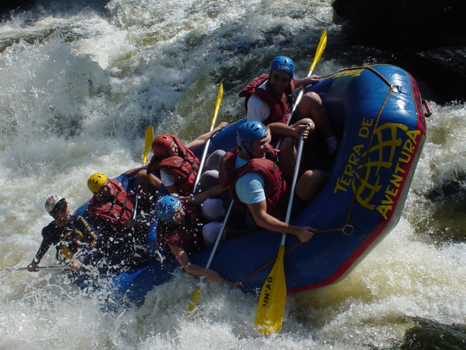 Inflatable rafting boat navigating white-water rapids on the crystal mountain river