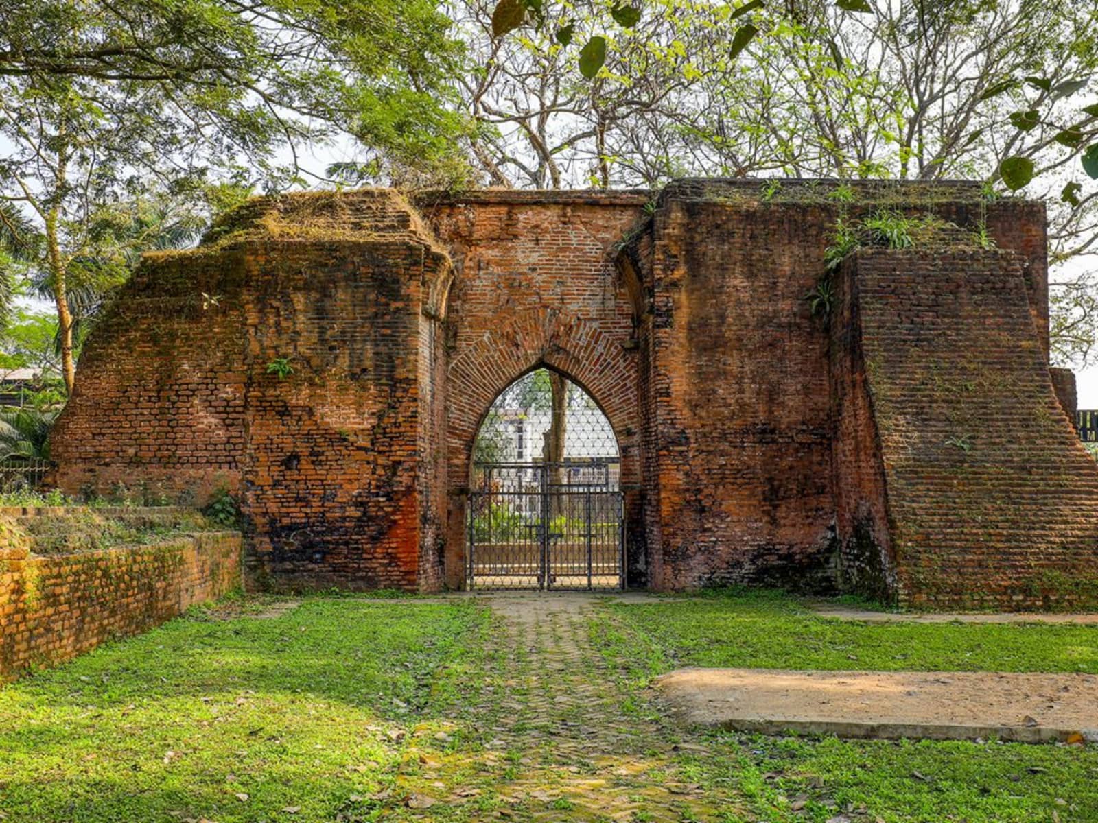 Carved sandstone monolith pillars at Kachari Rajbari