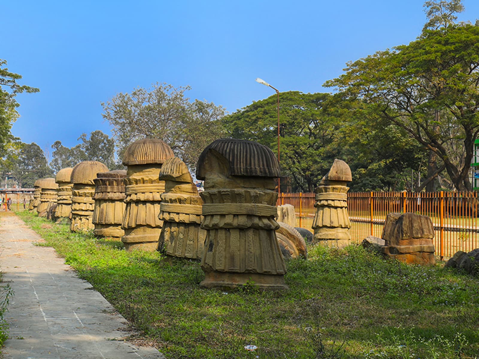 Medieval Dimasa Kachari carved stone structures standing in manicured grounds