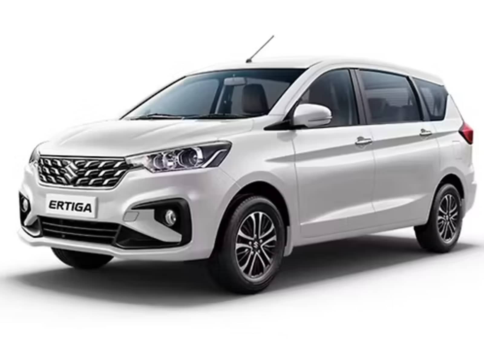 Maruti Suzuki Ertiga MUV presenting an aerodynamic profile with winged chrome grille, projector headlights, and dual-tone alloy wheels.