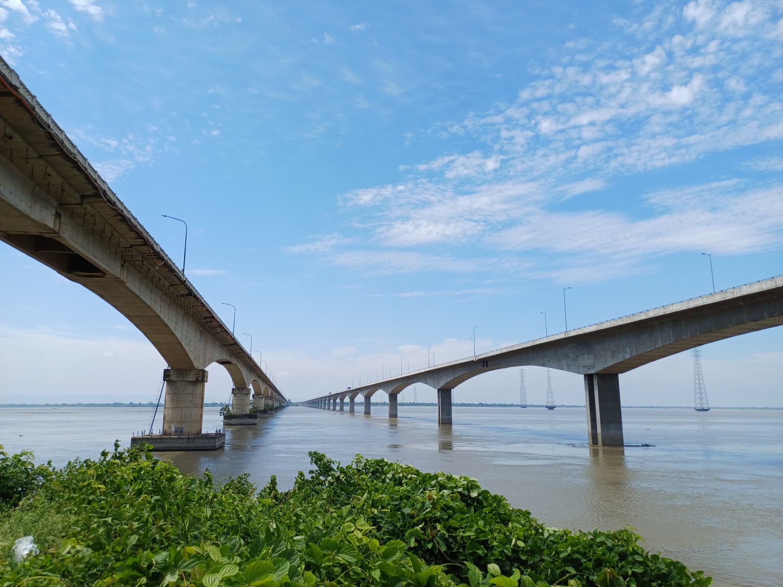 Kolia Bhomora Setu road bridge stretches across the vast Brahmaputra riverbed on a clear sunny day.