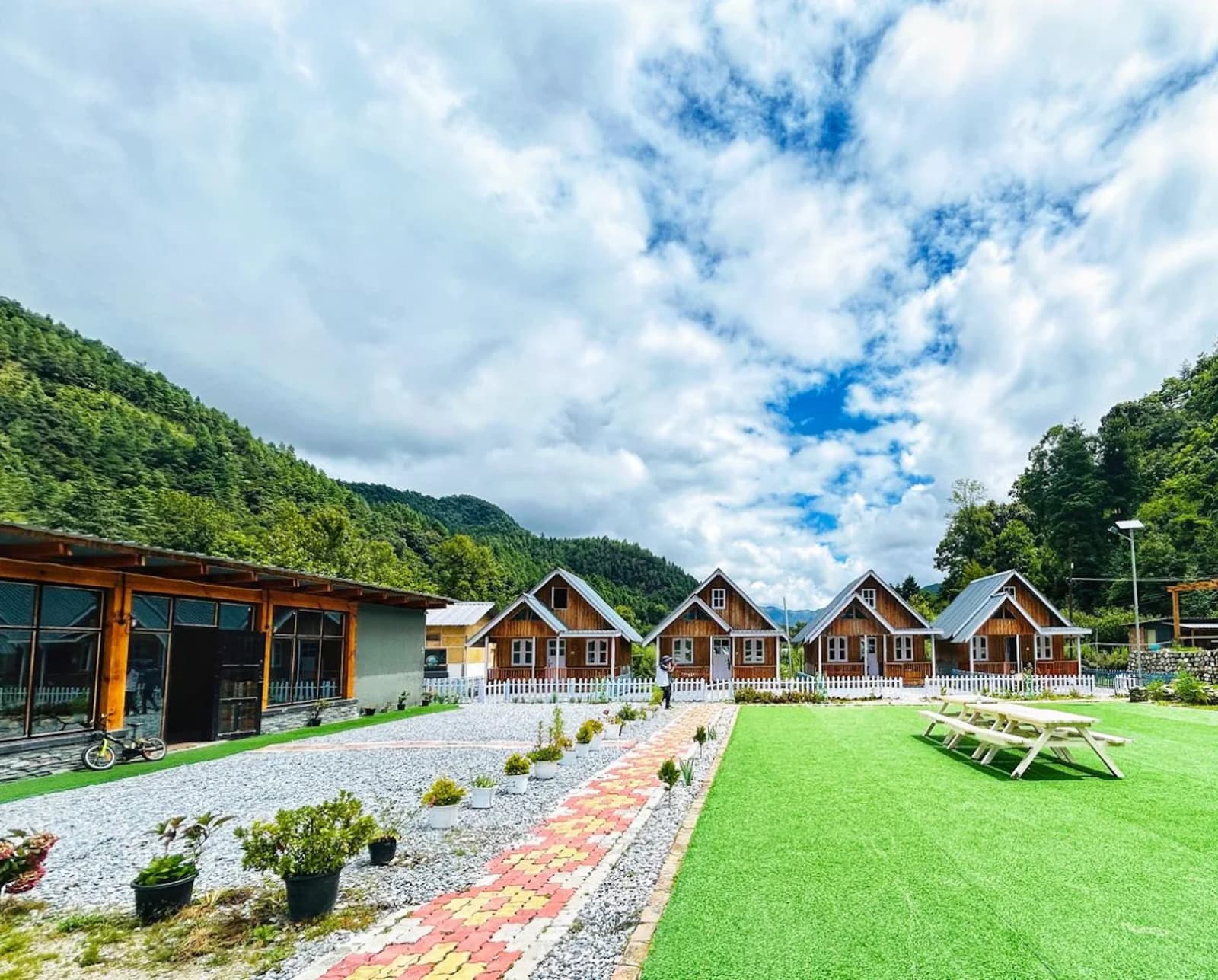 The Willow Resort wooden cottages set among private apple orchards in Shergaon.