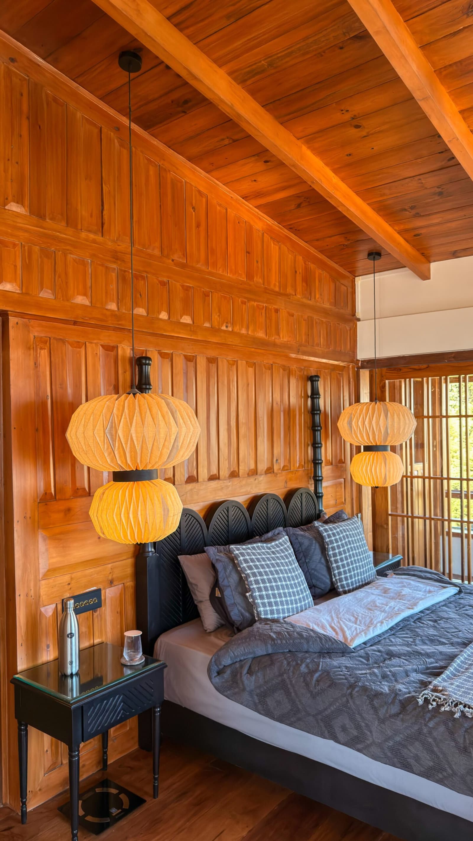 Vertical timber wall paneling elevates the main suite sleeping sanctuary.