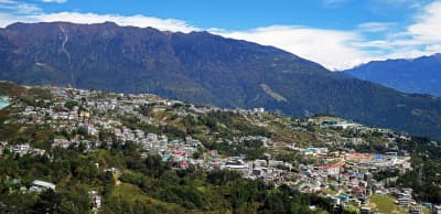 The colorful settlement of Tawang nestled under snow-capped Himalayan ridges.