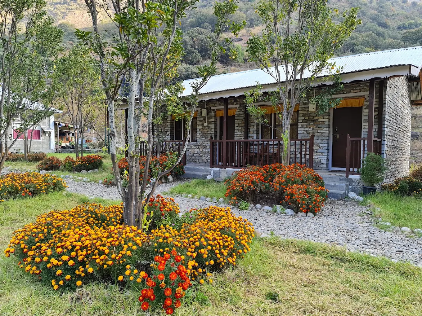 Dirang Boutique Cottages scenic riverside building and garden pathway in Dirang Valley.