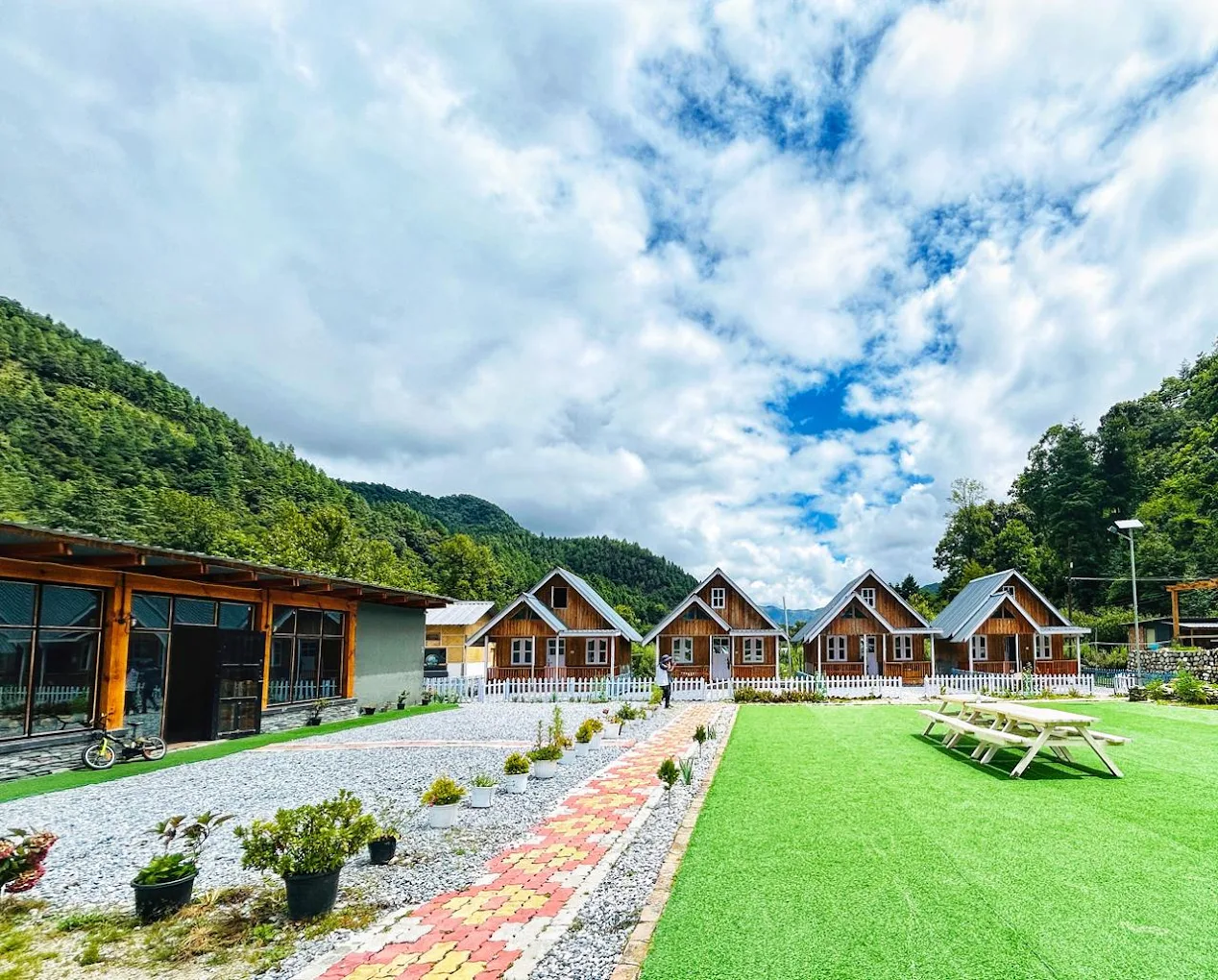 The Willow Resort wooden cottages set among private apple orchards in Shergaon.