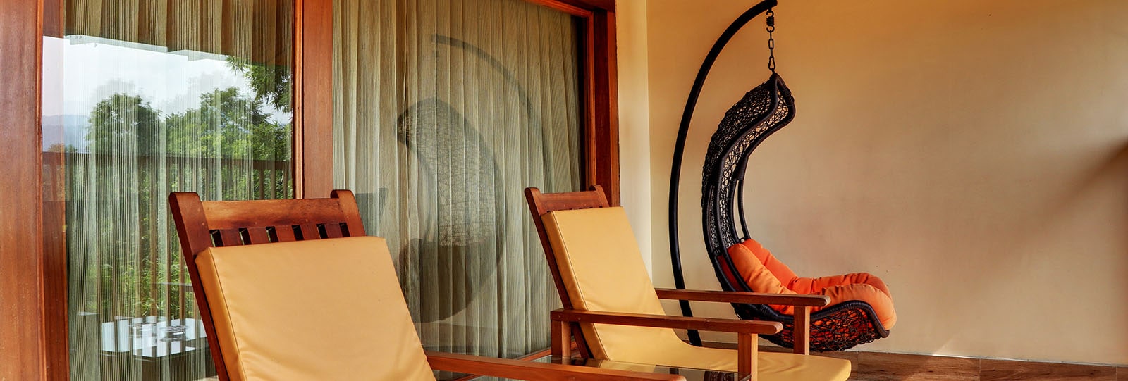 Shaded balconies provide comfortable outdoor swing seating overlooking quiet forest gardens.