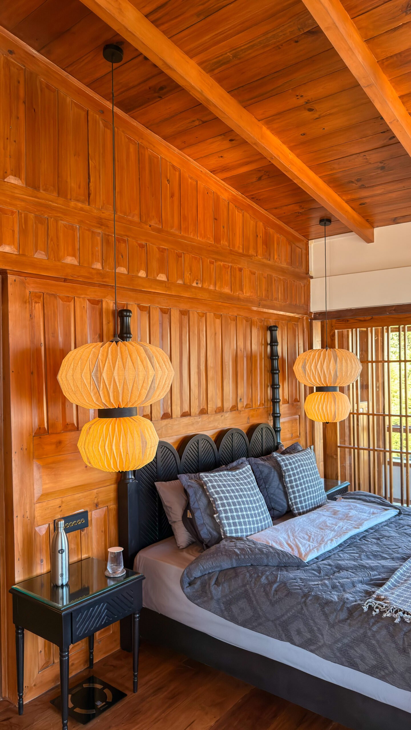 Vertical timber wall paneling elevates the main suite sleeping sanctuary.