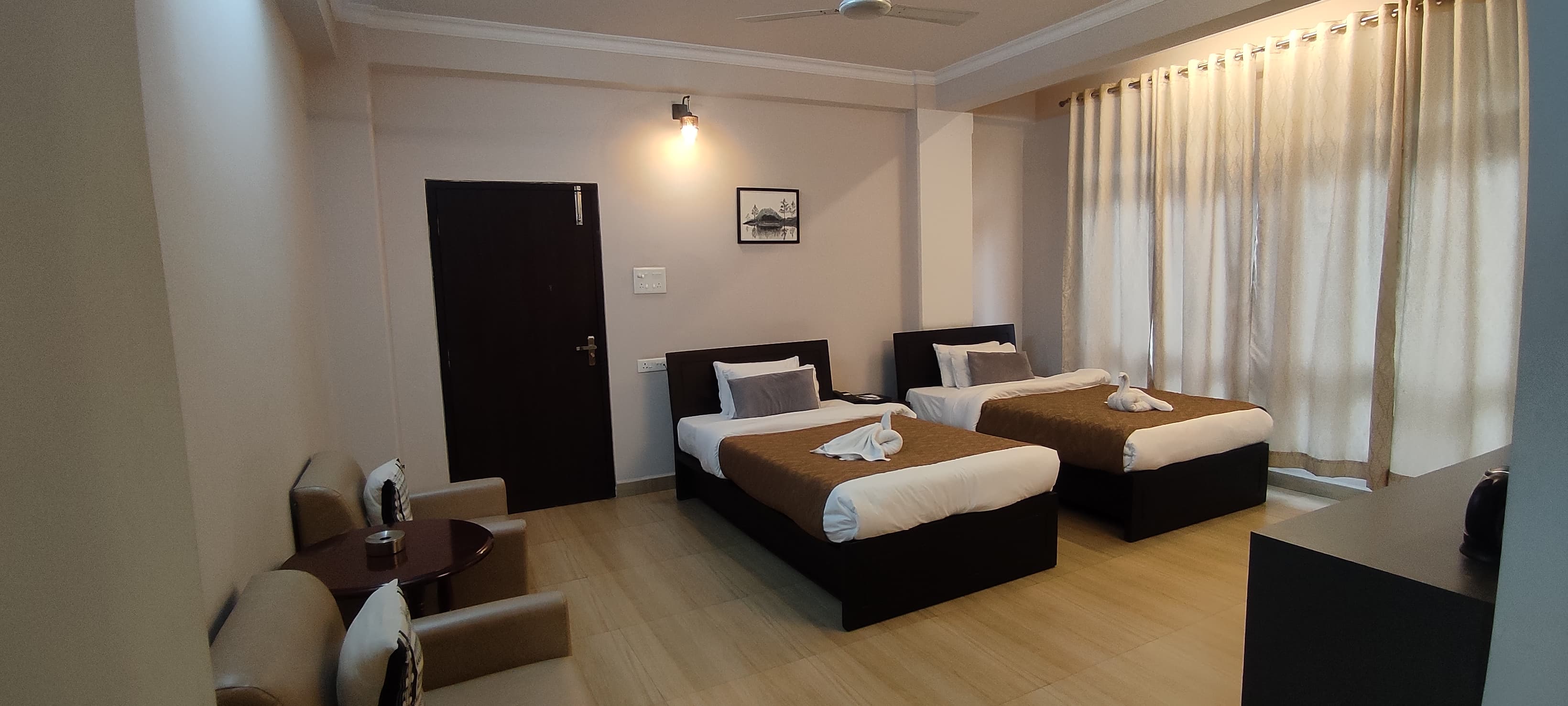 The Executive AC Room offers enhanced floor space with two single beds and a comfortable leather seating lounge.