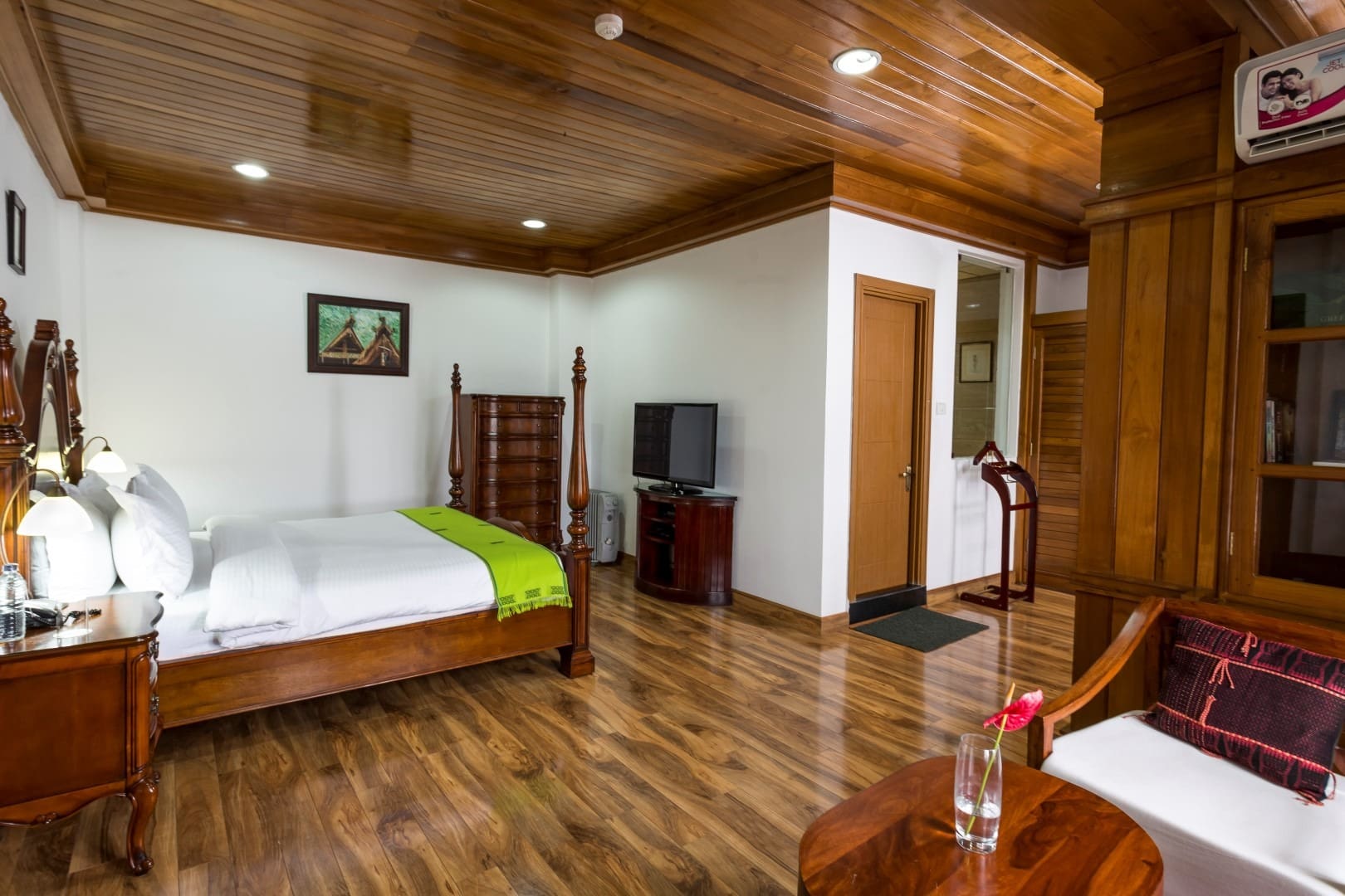 The luxurious Presidential Suite at Hotel Vivor features an expansive bedroom centered around a hand-carved teak poster king bed.