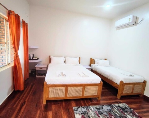 Pond View Executive AC Triple Room with king and single bed overlooking open lawns