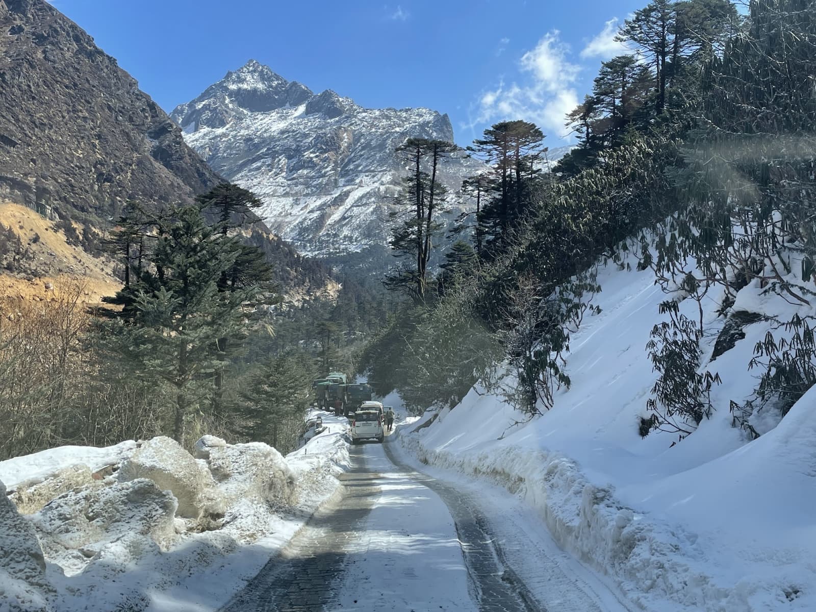 Winding snow-covered highway ascending to Sela Pass summit