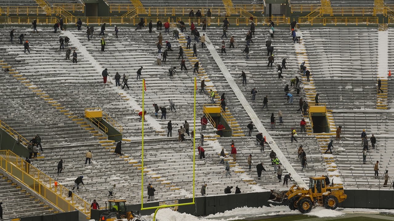 Fans shovel the frozen tundra of Lambeau Field
