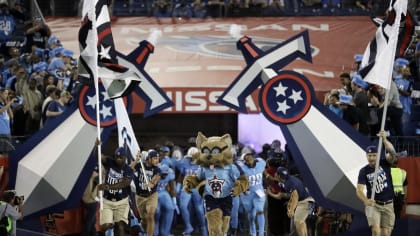 T-Rac, the Tennessee Titans mascot, poses for a picture with fans at a  training camp practice at the NFL football team's practice facility  Saturday, July 30, 2022, in Nashville, Tenn. (AP Photo/Mark