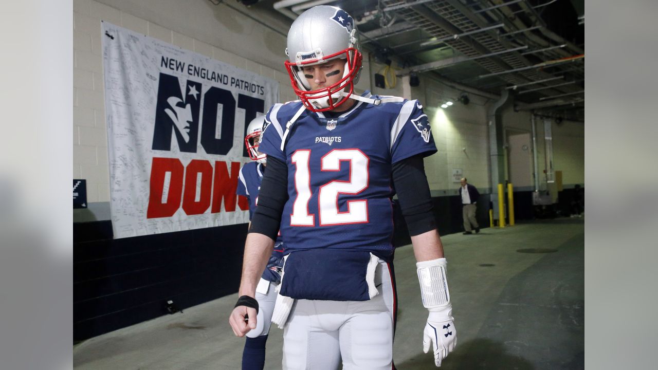 New England Patriots quarterback Tom Brady walks toward the field to warm up before the AFC championship NFL football game against the Jacksonville Jaguars, Sunday, Jan. 21, 2018, in Foxborough, Mass. (AP Photo/Winslow Townson)