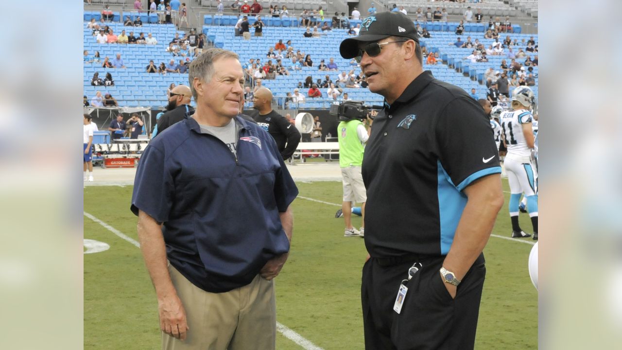 Carolina Panthers head coach Ron Rivera, front, hugs Cam Newton