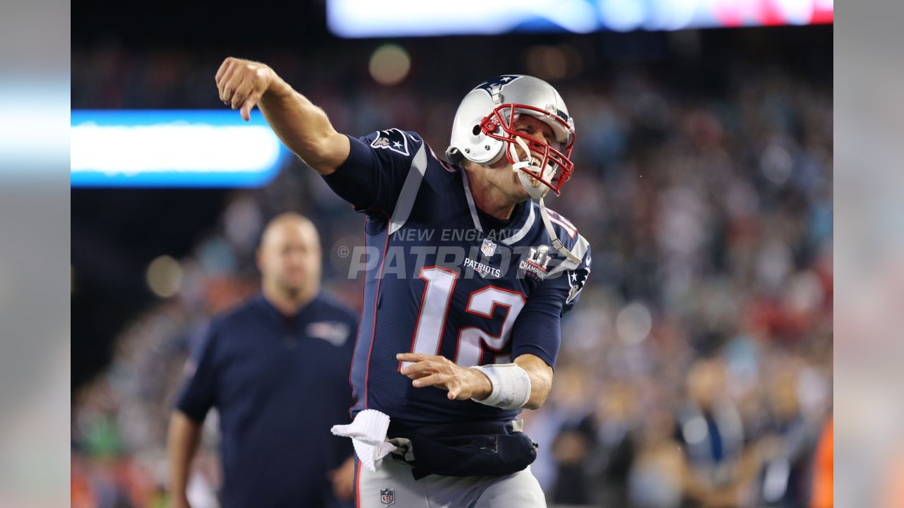 A fan walks by a giant helmet outside the New England Patriots Pro Shop  prior to an NFL football game, Sunday, Sept. 12, 2021, in Foxborough, Mass.  (AP Photo/Steven Senne Stock Photo 