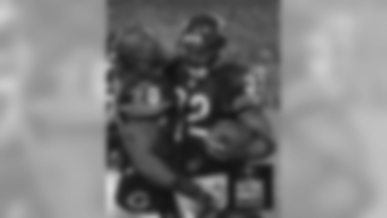Thomas Jones congratulates Cedric Benson after his fourth quarter touchdown. Bears Historic Moments - Chicago Tribune