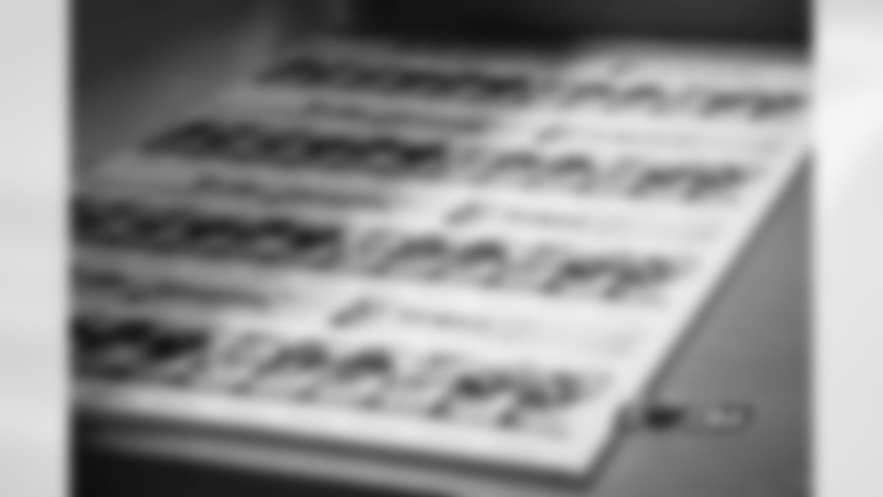 A batch of tickets that will be laminated, foil stamped, perforated, and cut before being shipped to season ticket holders.