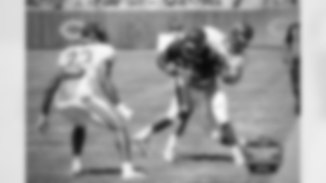 RB Jeremy Langford tackled by LB John Timu.