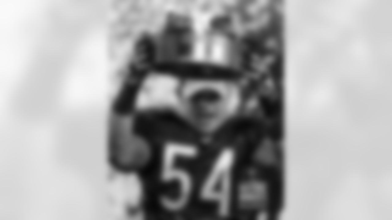 Brian Urlacher holds up the George S. Halas Trophy after the game. Bears Historic Moments - Chicago Tribune