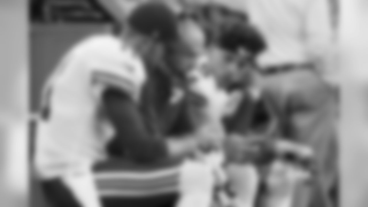 Nagy, Smith and Mahomes analyze game information on the Chiefs sideline.