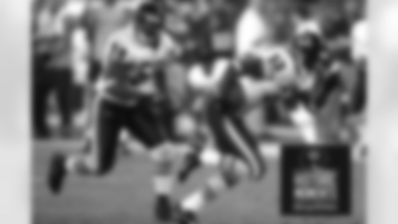 Lance Briggs looks to fend off any tacklers as Charles Tillman picks up a fumble and heads for the endzone in the fourth quarter. Bears Historic Moments - Chicago Tribune