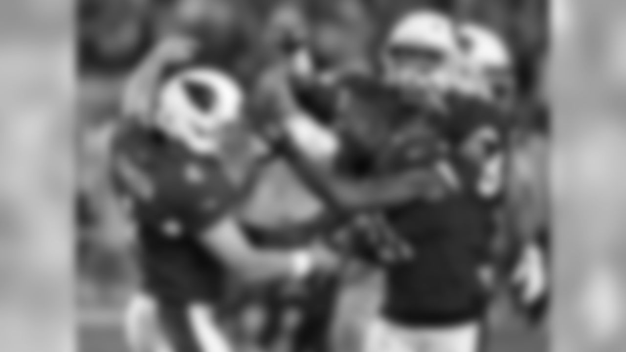 Phil Dawson (left) celebrates with Patrick Peterson (right) after hitting the game-winning field goal