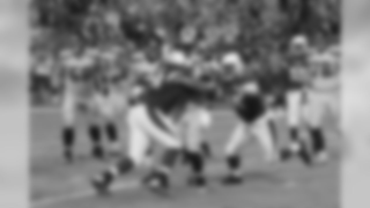 DT Corey Peters gets a hit on Seahawks QB Russell Wilson