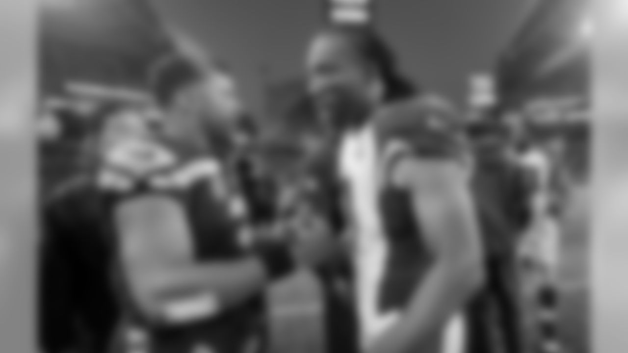 Russell Wilson (left) and Larry Fitzgerald (right) meet up after the game