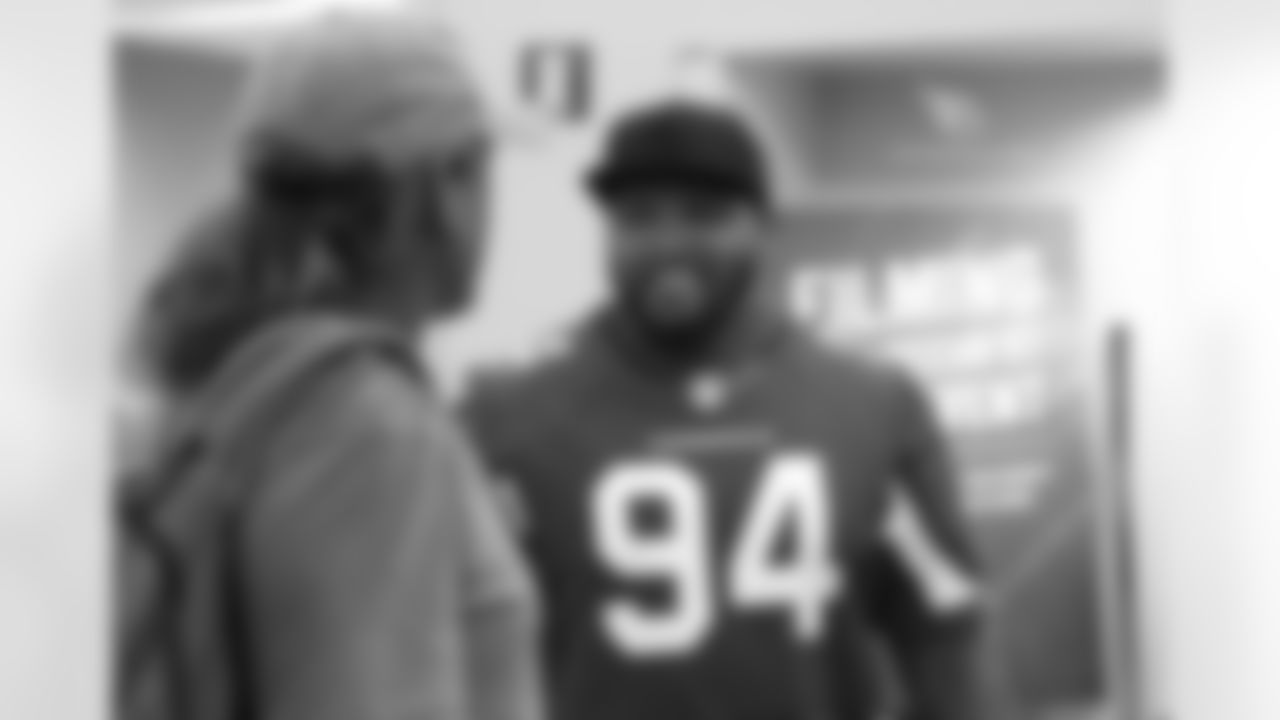 DT Xavier Williams talks with a fan