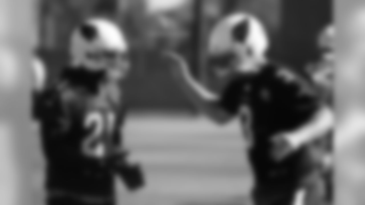 CB Patrick Peterson (left) and QB Carson Palmer slap five during OTAs