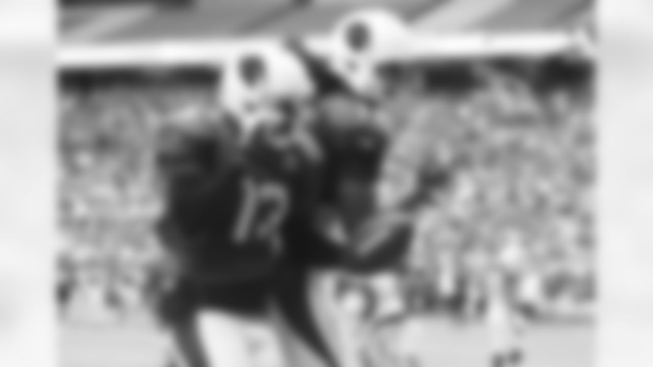 WR Jaron Brown (left) celebrates his touchdown catch on a WR pass by Larry Fitzgerald