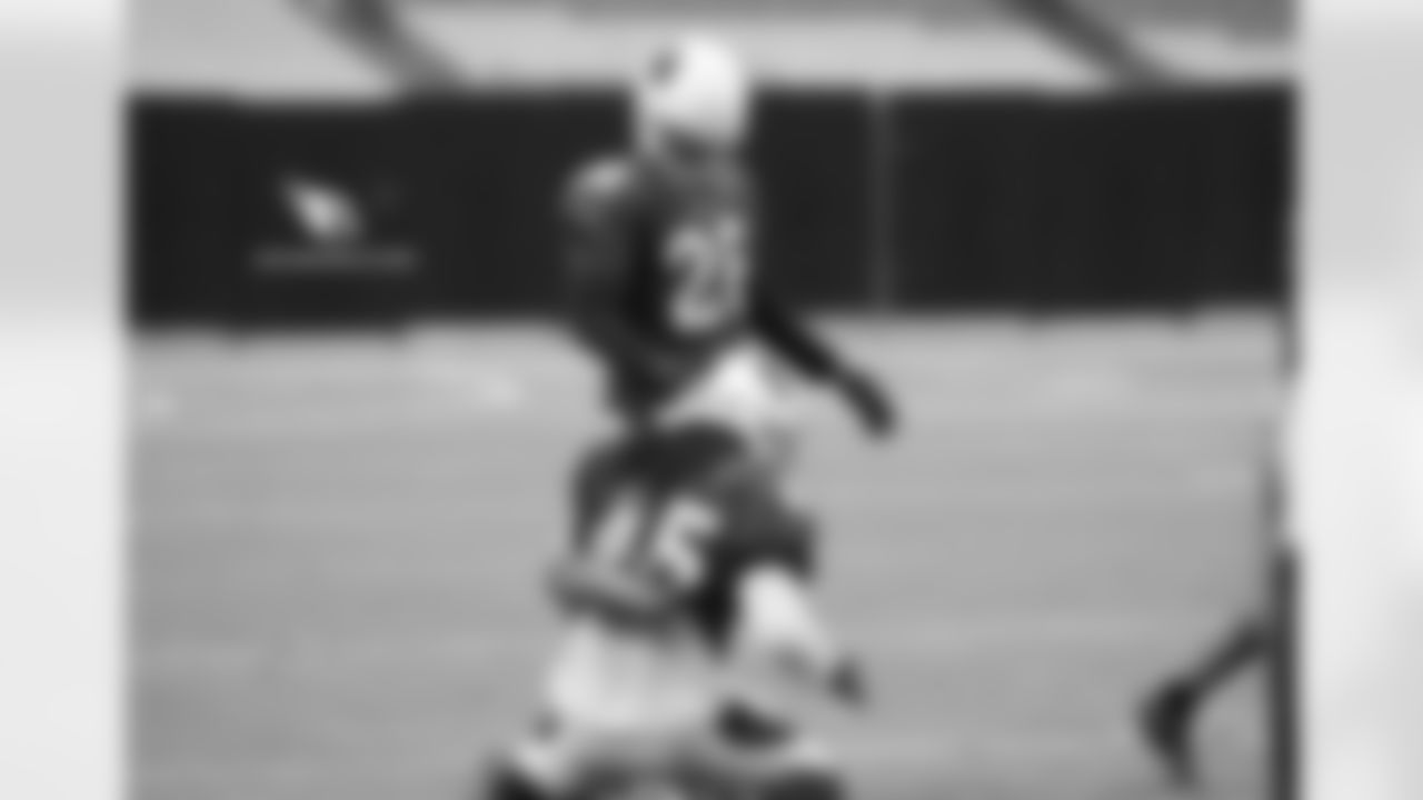 CB Justin Bethel pats LB Josh Bynes on the head