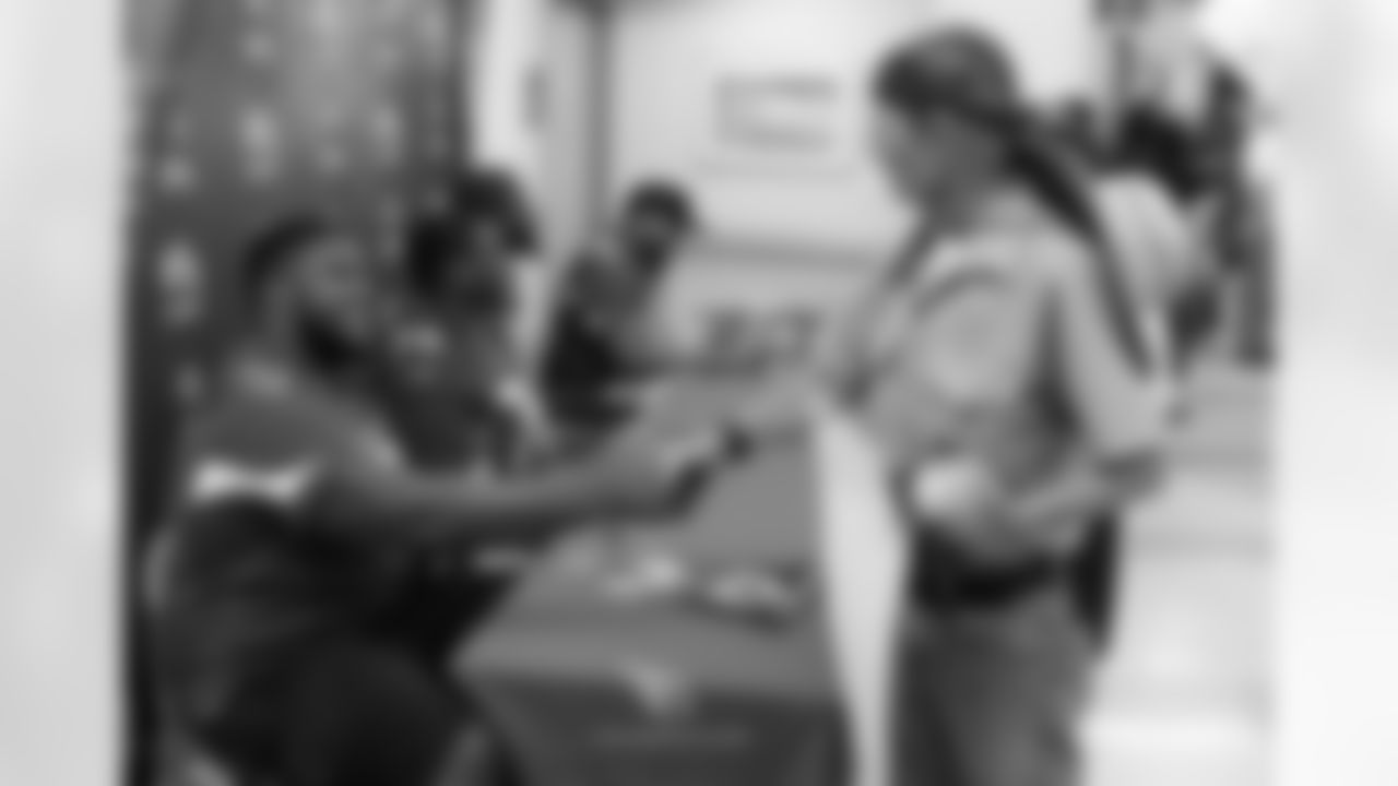 G Kaleb Johnson shakes the hand of a veteran