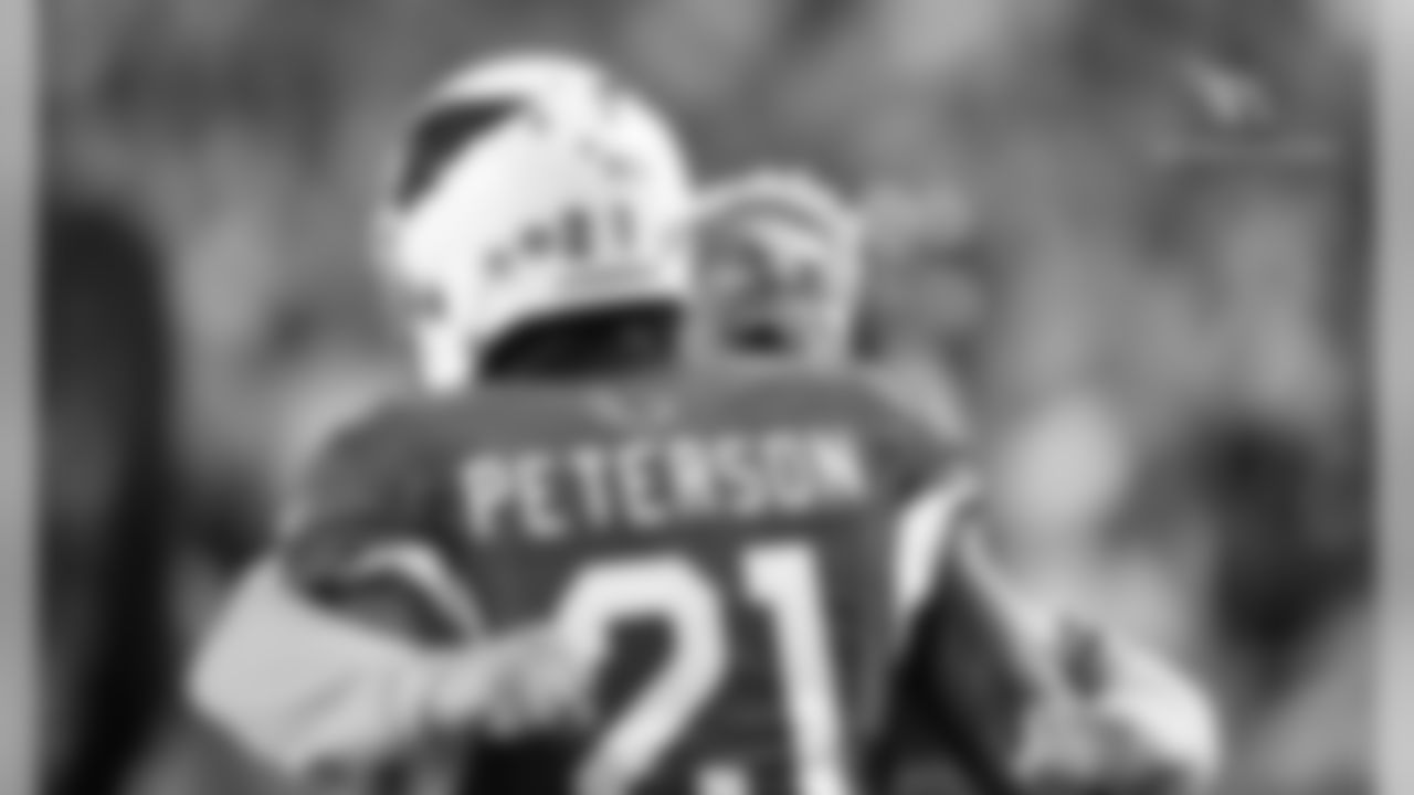 CB Patrick Peterson gets a hug from S Tyrann Mathieu after a game-clinching interception against Washington