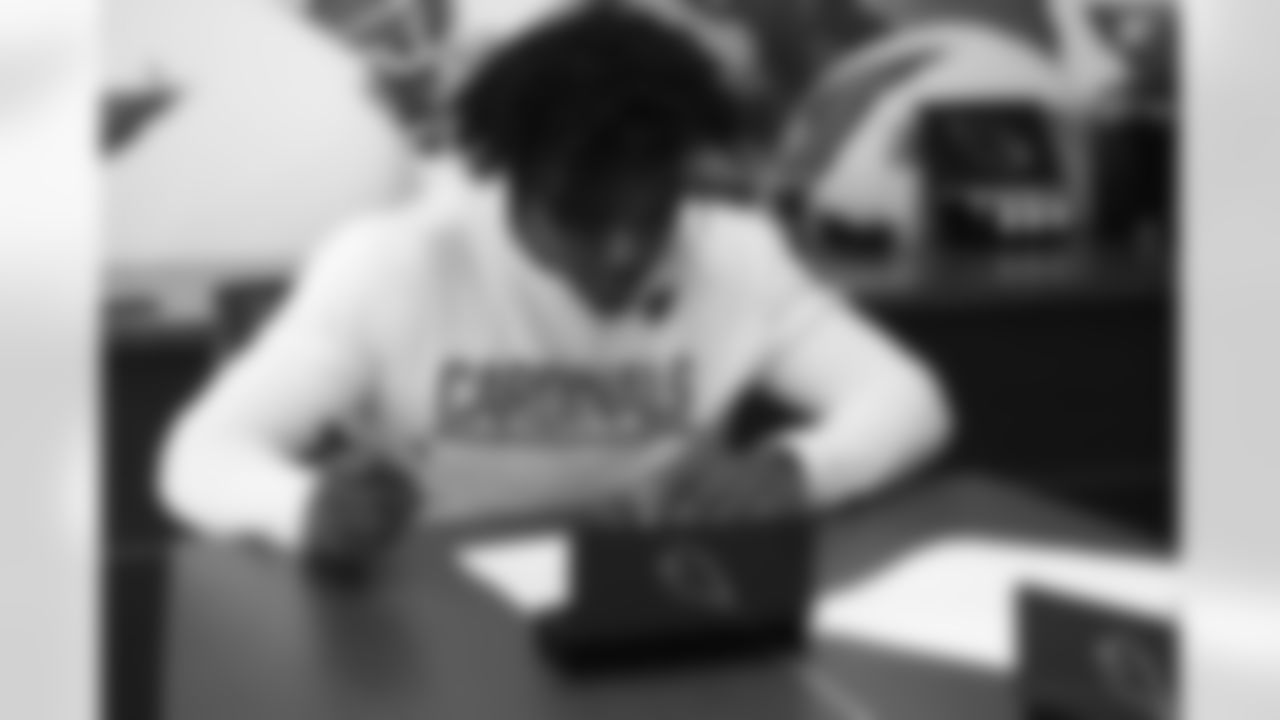 Third-round pick WR Chad Williams looks over his contract