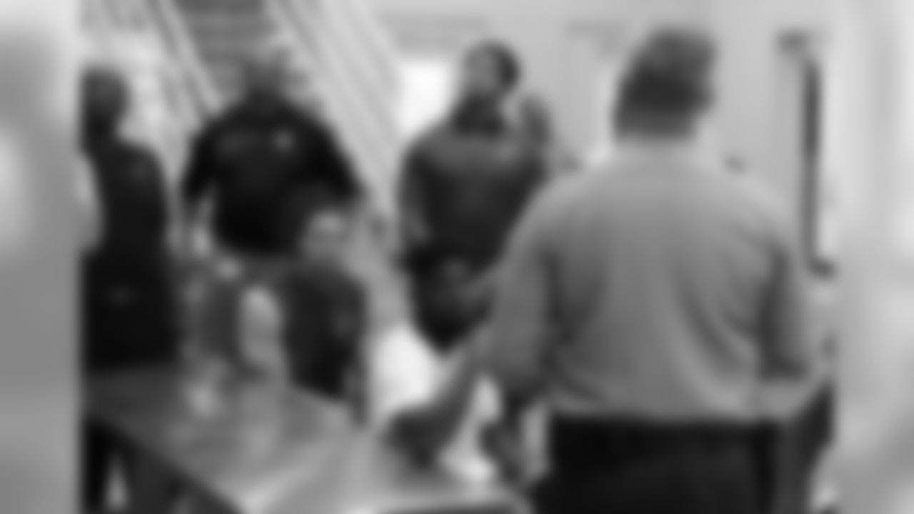 WR Krishawn Hogan (left) and RB T.J. Hogan listen to the guard during their tour of the jail
