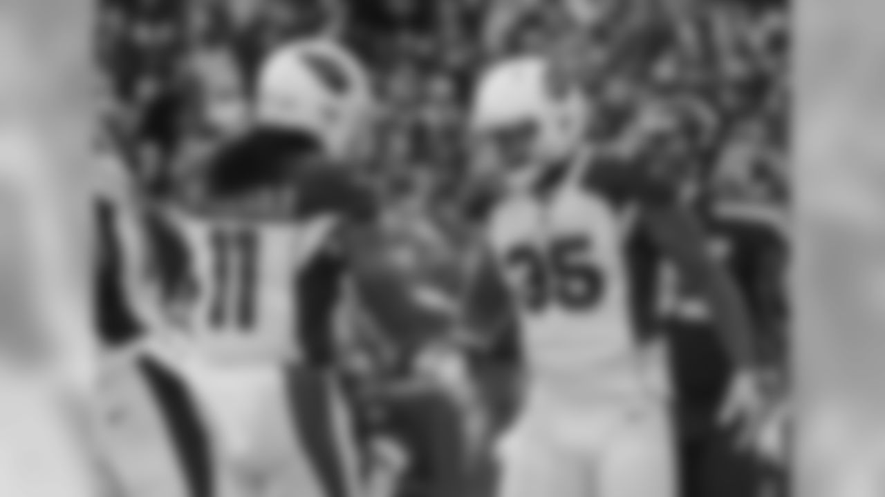Larry Fitzgerald (left) congratulates RB Elijhaa Penny (right) after punching in a touchdown